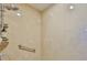 Close up of the neutral tile shower with showerhead and shelving at 6468 Rubia Cir, Apollo Beach, FL 33572