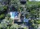 Aerial view of a home featuring a backyard pool, mature trees, and lush landscaping at 6602 Winding Brook Dr, New Port Richey, FL 34655