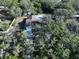 Aerial view of a single-Gathering home with mature trees and lush landscaping at 6602 Winding Brook Dr, New Port Richey, FL 34655