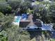 Aerial view of a pool home featuring a large backyard, mature trees, and private setting at 6602 Winding Brook Dr, New Port Richey, FL 34655