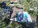 Aerial view of a single-Gathering home with a pool and covered patio surrounded by mature trees at 6602 Winding Brook Dr, New Port Richey, FL 34655