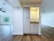 Compact bar area with wood cabinets, tile backsplash, granite counters, and a light fixture at 6602 Winding Brook Dr, New Port Richey, FL 34655
