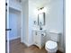 Bright bathroom features a modern vanity, mirror, and toilet at 6602 Winding Brook Dr, New Port Richey, FL 34655