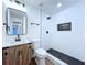 Stylish bathroom with white subway tile, a sleek black shower and vanity with rustic wood grain at 6602 Winding Brook Dr, New Port Richey, FL 34655