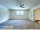 Spacious carpeted bedroom with a modern ceiling fan and ample natural light at 6602 Winding Brook Dr, New Port Richey, FL 34655