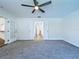 Bedroom with carpeting, ceiling fan and french doors to hallway at 6602 Winding Brook Dr, New Port Richey, FL 34655