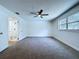 Bedroom with carpeting, ceiling fan and bathroom in view at 6602 Winding Brook Dr, New Port Richey, FL 34655