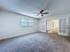 Bedroom with carpeting, ceiling fan and french doors to additional room at 6602 Winding Brook Dr, New Port Richey, FL 34655