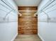 Walk-in closet with custom wood paneling and installed shelving at 6602 Winding Brook Dr, New Port Richey, FL 34655
