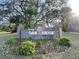 Oak Ridge deed restricted community signage with lush landscaping at 6602 Winding Brook Dr, New Port Richey, FL 34655