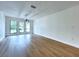 Bright dining room featuring wood floors, a modern chandelier, and natural light from large windows at 6602 Winding Brook Dr, New Port Richey, FL 34655