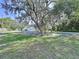 Charming home with a well-manicured lawn and mature trees, providing shade at 6602 Winding Brook Dr, New Port Richey, FL 34655