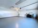Spacious garage with sealed floors, ceiling fan and door to inside at 6602 Winding Brook Dr, New Port Richey, FL 34655
