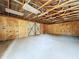 Interior view of an empty garage featuring wooden walls and an exposed beam ceiling at 6602 Winding Brook Dr, New Port Richey, FL 34655