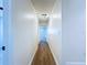 Well-lit hallway features clean white walls and modern wood-look flooring throughout at 6602 Winding Brook Dr, New Port Richey, FL 34655