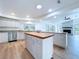Well-equipped kitchen with stainless steel appliances, central island, and ample cabinet space at 6602 Winding Brook Dr, New Port Richey, FL 34655