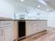 Kitchen area features granite countertops, beverage cooler, wood cabinets, and views of the fireplace at 6602 Winding Brook Dr, New Port Richey, FL 34655