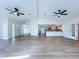 Spacious living room boasts open floor plan, modern ceiling fans, and neutral paint at 6602 Winding Brook Dr, New Port Richey, FL 34655