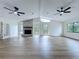 Bright, open living room with vaulted ceiling, stone fireplace, new floors and lots of natural light at 6602 Winding Brook Dr, New Port Richey, FL 34655