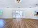 Living room boasting new light flooring and access to the kitchen at 6602 Winding Brook Dr, New Port Richey, FL 34655