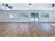 Large living room with updated floors, neutral paint, modern ceiling fans, and lots of natural light at 6602 Winding Brook Dr, New Port Richey, FL 34655
