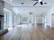 Light-filled living room with stone fireplace, cathedral ceiling, and attractive floors at 6602 Winding Brook Dr, New Port Richey, FL 34655