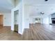 Open-concept living area featuring new flooring, stone fireplace, and access to an enclosed porch at 6602 Winding Brook Dr, New Port Richey, FL 34655