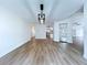Open living space with light wood floors and contemporary light fixtures at 6602 Winding Brook Dr, New Port Richey, FL 34655