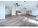 Open-concept living room with stylish flooring, ceiling fans, and ample space at 6602 Winding Brook Dr, New Port Richey, FL 34655