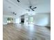 Spacious living room with vaulted ceilings, stone fireplace, and natural light at 6602 Winding Brook Dr, New Port Richey, FL 34655