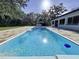 Sparkling private pool with sunny patio area and lush backyard landscaping at 6602 Winding Brook Dr, New Port Richey, FL 34655