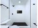 Contemporary walk-in shower boasts black hardware, white subway tile, and a black-tiled shower floor at 6602 Winding Brook Dr, New Port Richey, FL 34655