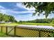 Serene backyard view overlooking a pond, surrounded by lush greenery and a wooden fence at 6628 Summer Haven Dr, Riverview, FL 33578