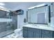 Modern bathroom with dark gray tiled walk-in shower and gray vanity with white countertop at 6628 Summer Haven Dr, Riverview, FL 33578