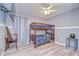 Bedroom featuring bunk beds, light gray walls, wood-look floors, and a ceiling fan at 6628 Summer Haven Dr, Riverview, FL 33578