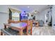 Open dining area featuring a large wooden table, chairs, bench seating, and an aquarium at 6628 Summer Haven Dr, Riverview, FL 33578