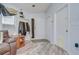 Bright entryway featuring light wood floors, white walls, and convenient coat storage at 6628 Summer Haven Dr, Riverview, FL 33578