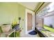 View of home's front door with plants, a small mat, and wood fence in the background at 6628 Summer Haven Dr, Riverview, FL 33578
