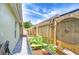 Backyard view of home with planted garden, wood fence, and walkway at 6628 Summer Haven Dr, Riverview, FL 33578