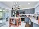 Modern kitchen featuring granite countertops, dark cabinets, and stainless steel appliances at 6628 Summer Haven Dr, Riverview, FL 33578