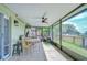 Screened patio featuring tile floors, ceiling fan, and views of the fenced yard at 6628 Summer Haven Dr, Riverview, FL 33578