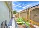 Enclosed side yard featuring a garden bed and a wooden fence for added privacy at 6628 Summer Haven Dr, Riverview, FL 33578