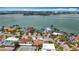 Captivating aerial view of waterfront homes highlighting manicured landscaping, swimming pools, and the bay at 7125 S Shore S Dr, St Petersburg, FL 33707