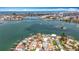 Beautiful aerial view of waterfront neighborhood showcasing lush landscaping and proximity to the open bay at 7125 S Shore S Dr, St Petersburg, FL 33707