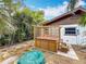 Well-maintained backyard highlighting a hot tub under a wooden pergola and mature palm trees at 7125 S Shore S Dr, St Petersburg, FL 33707