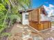 Private backyard featuring a hot tub, surrounded by tropical landscaping and a stone pathway at 7125 S Shore S Dr, St Petersburg, FL 33707