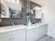 Contemporary bathroom showcases a dual sink vanity with quartz countertops, sleek lighting, and decorative wall tiling at 7125 S Shore S Dr, St Petersburg, FL 33707