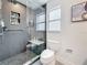 Upgraded bathroom featuring a pebble-floor shower with a built-in niche, and modern fixtures for a luxurious feel at 7125 S Shore S Dr, St Petersburg, FL 33707