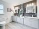 Spacious bathroom with double vanity, sleek cabinets, wood-look tile, and modern fixtures at 7125 S Shore S Dr, St Petersburg, FL 33707