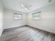Bedroom with two windows, a ceiling fan, and natural light at 7125 S Shore S Dr, St Petersburg, FL 33707
